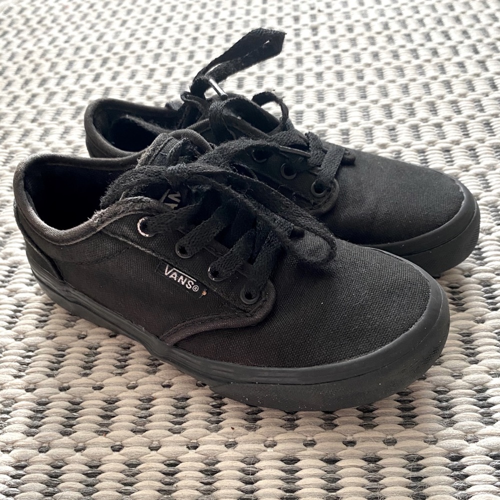 All black Vans tennis shoes